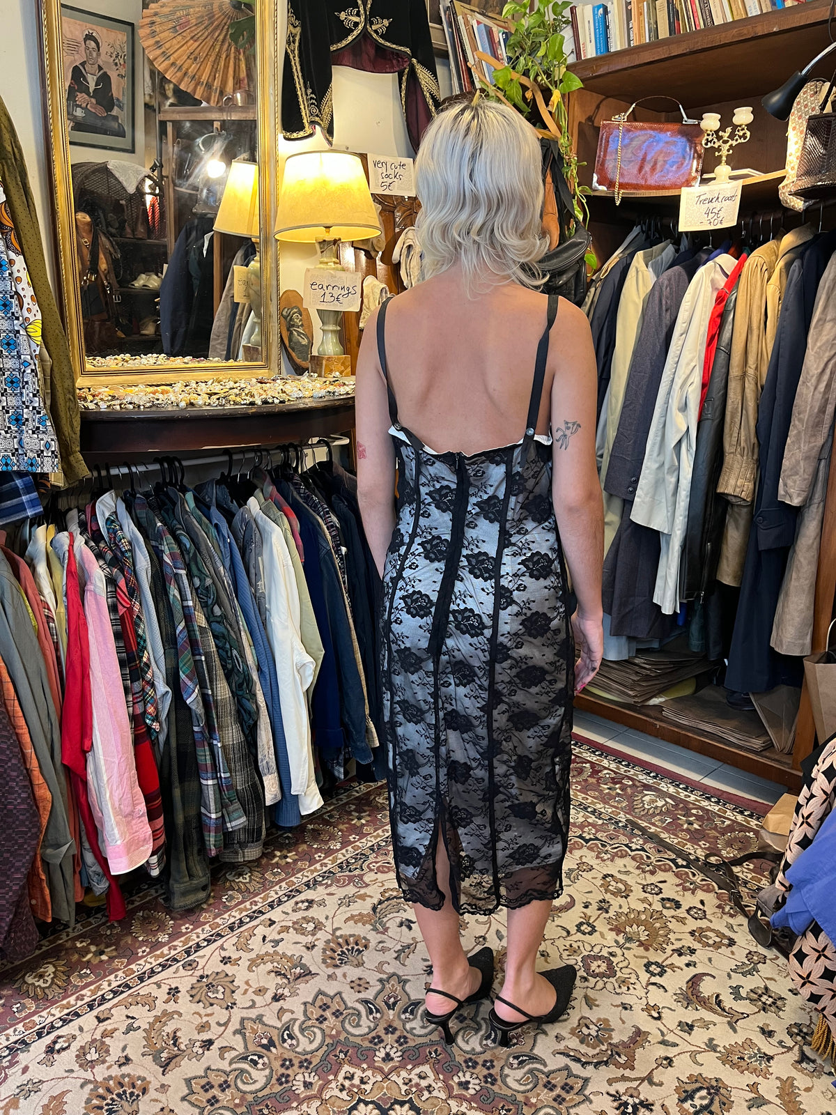 Elegant black lace midi dress with a contrasting silver lining, delicate floral detailing and slim straps. The fitted silhouette creates a timeless, feminine look with a romantic vintage feel