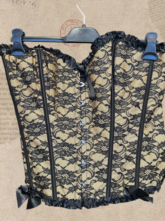 Victorian beige corset with black floral lace and satin bows. Adjustable lace-up back for a flattering fit. A romantic statement piece with gothic charm.