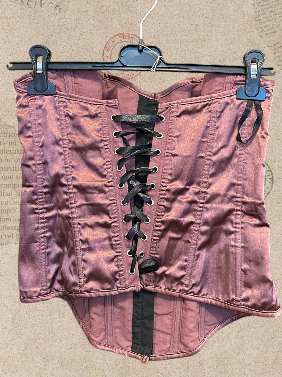 Dusty rose satin corset with intricate black floral lace. Adjustable lace-up back for a flattering fit. A romantic statement piece with gothic charm.
