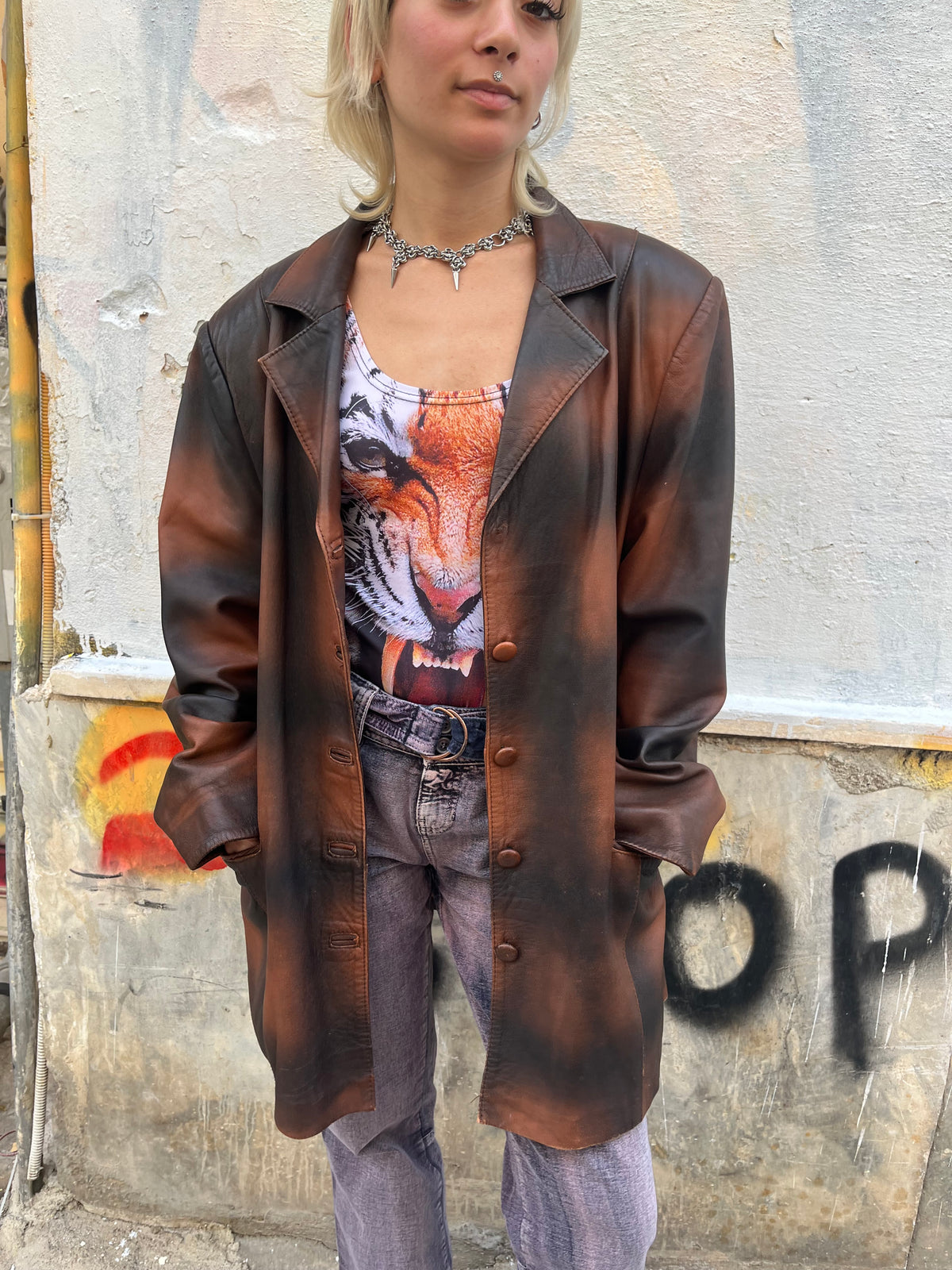 Oversized vintage leather blazer featuring a unique distressed brown and black finish. A statement piece with a relaxed fit, classic lapels, and button-front closure.