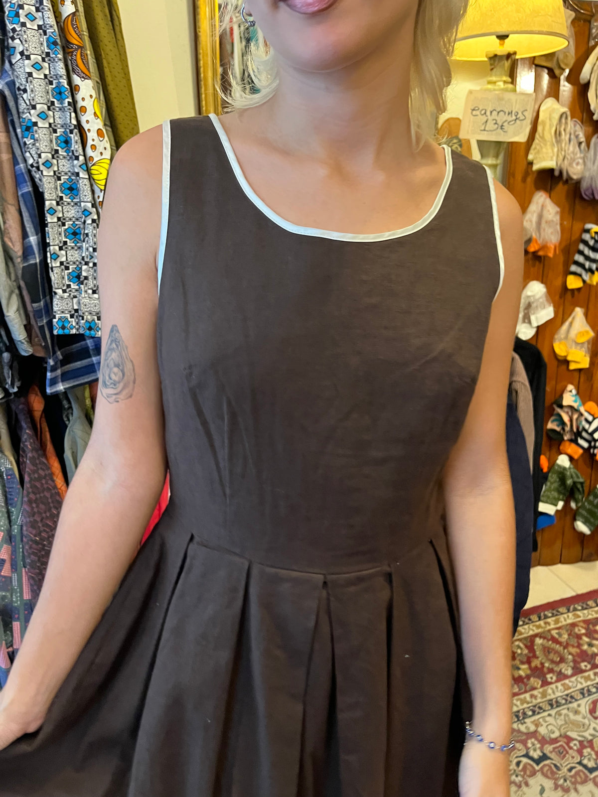 Elegant vintage-inspired wrap midi dress with a geometric print, contrasting black lapels and a tie waist. A timeless statement piece with a flattering silhouette and effortlessly chic feel.