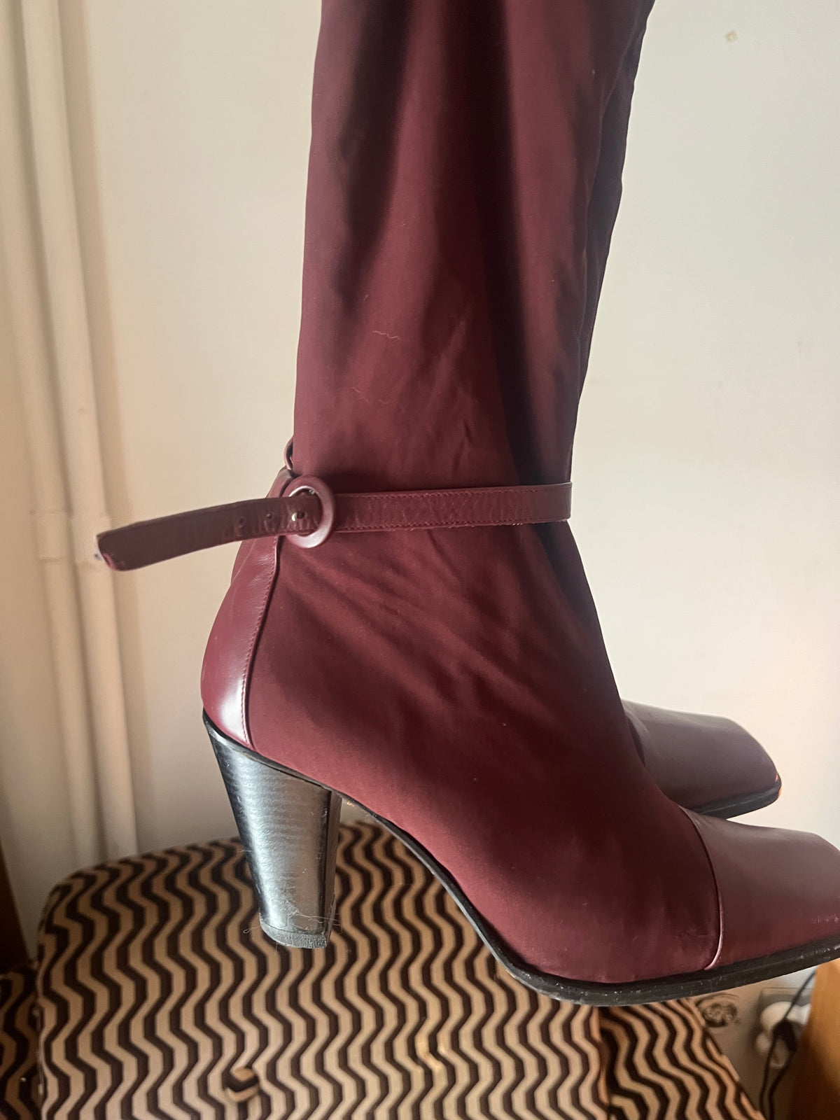 Deep burgundy sock boots with a sleek square toe and mid-height heel.