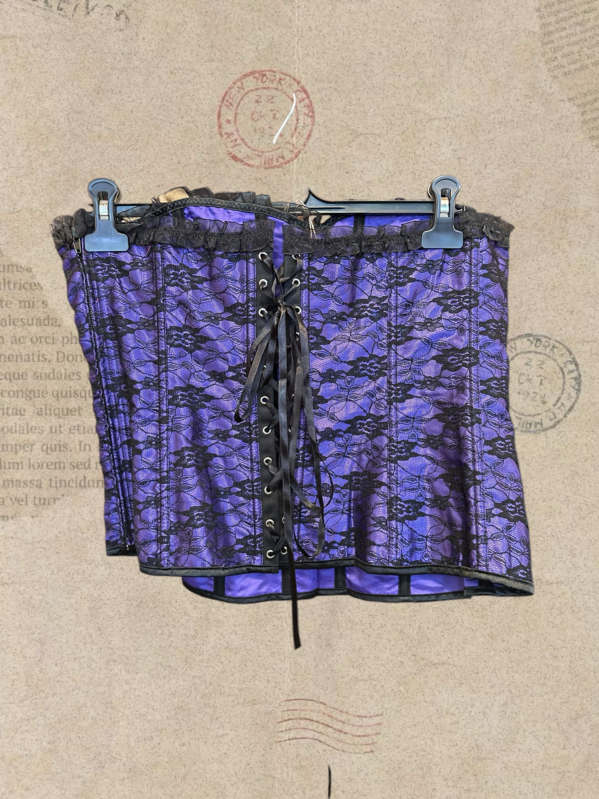 Gothic purple satin corset with black floral lace and ruffled trims. Adjustable lace-up design for a perfect fit. A romantic statement piece with Victorian charm.