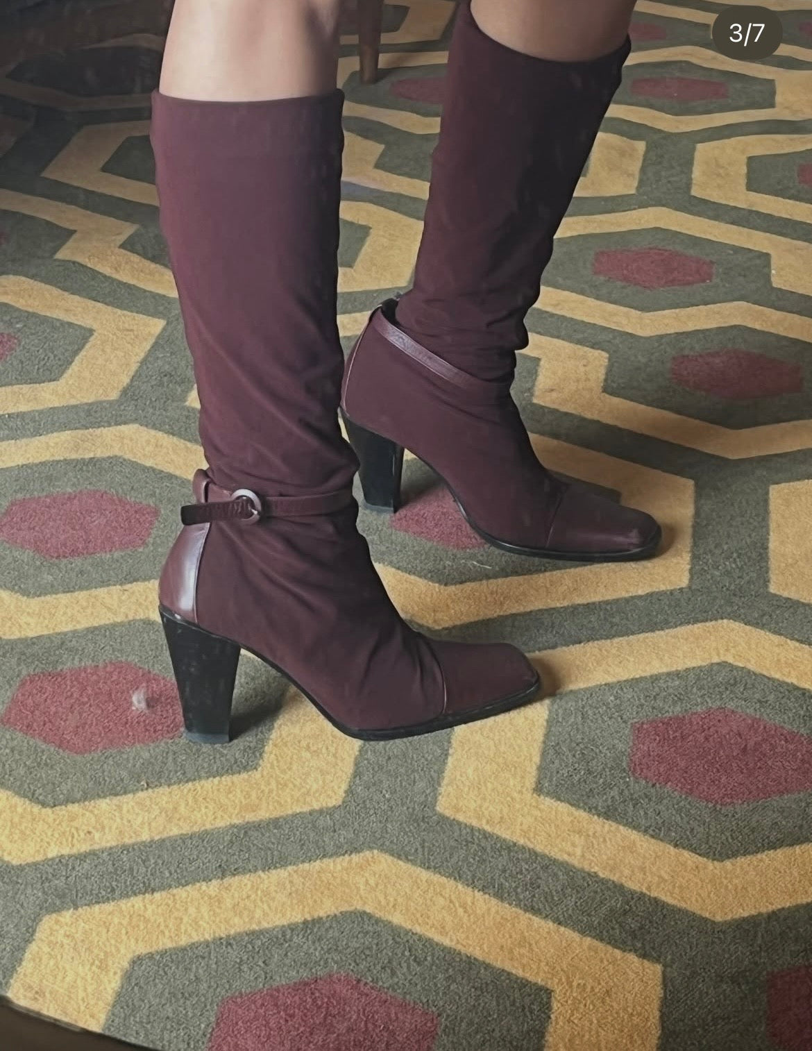 Deep burgundy sock boots with a sleek square toe and mid-height heel.