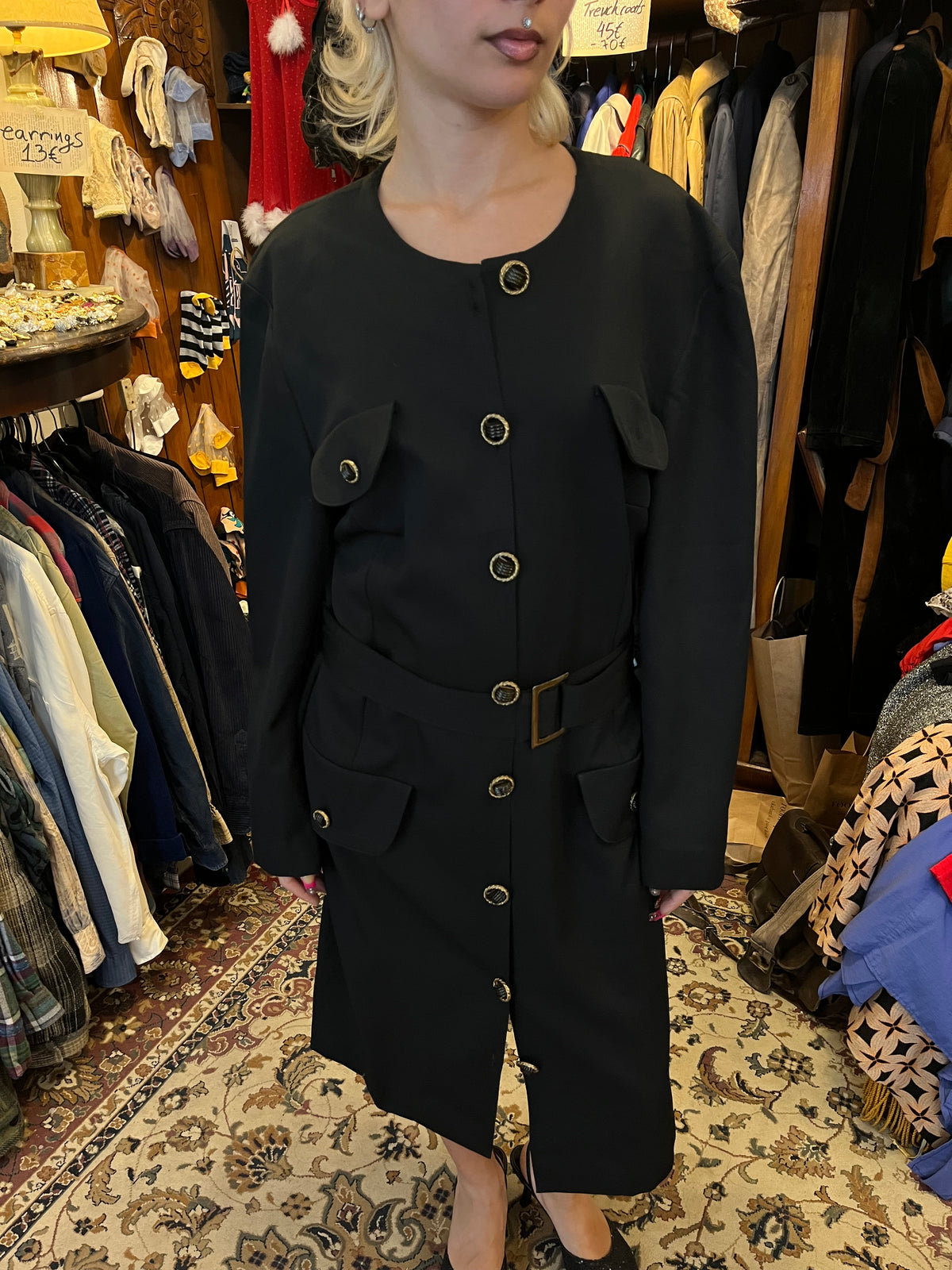 Vintage black midi coat dress featuring statement gold-tone buttons, multiple flap pockets and a matching waist belt. A structured, timeless silhouette with an elegant military-inspired feel.