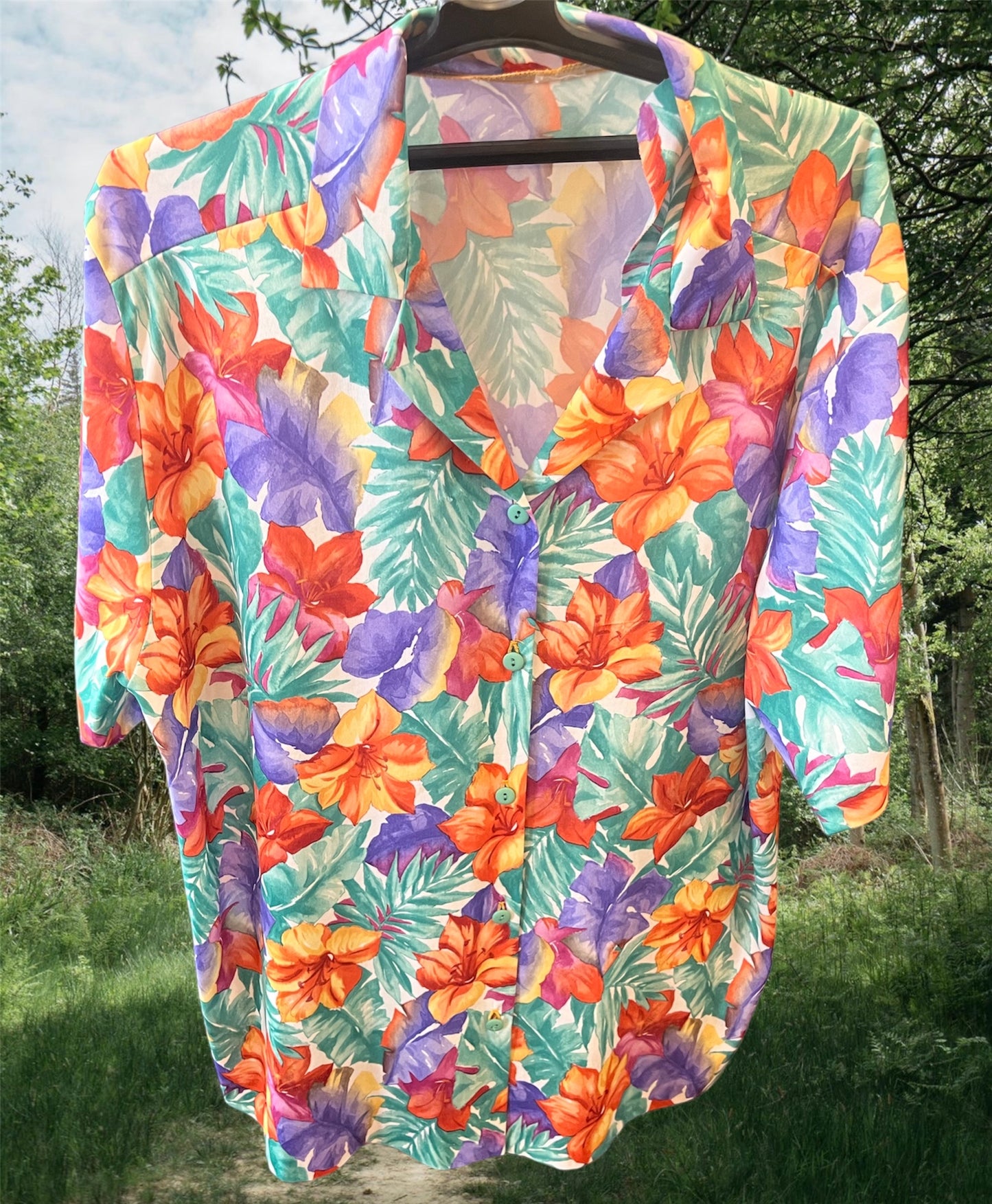 Floral short sleeved button up shirt .