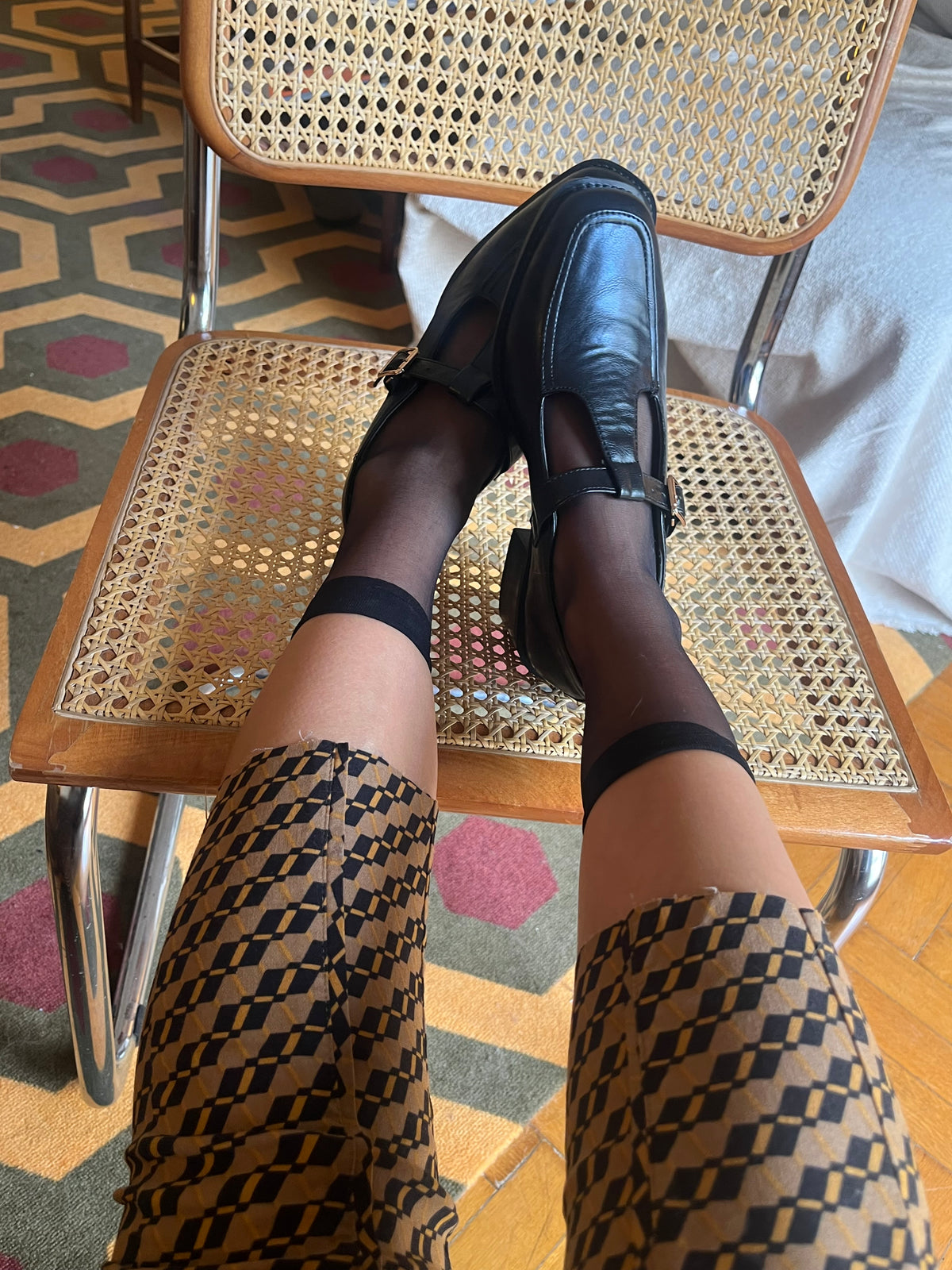 Classic black Mary Jane shoes with a T-strap, gold-tone buckle and a chic low block heel