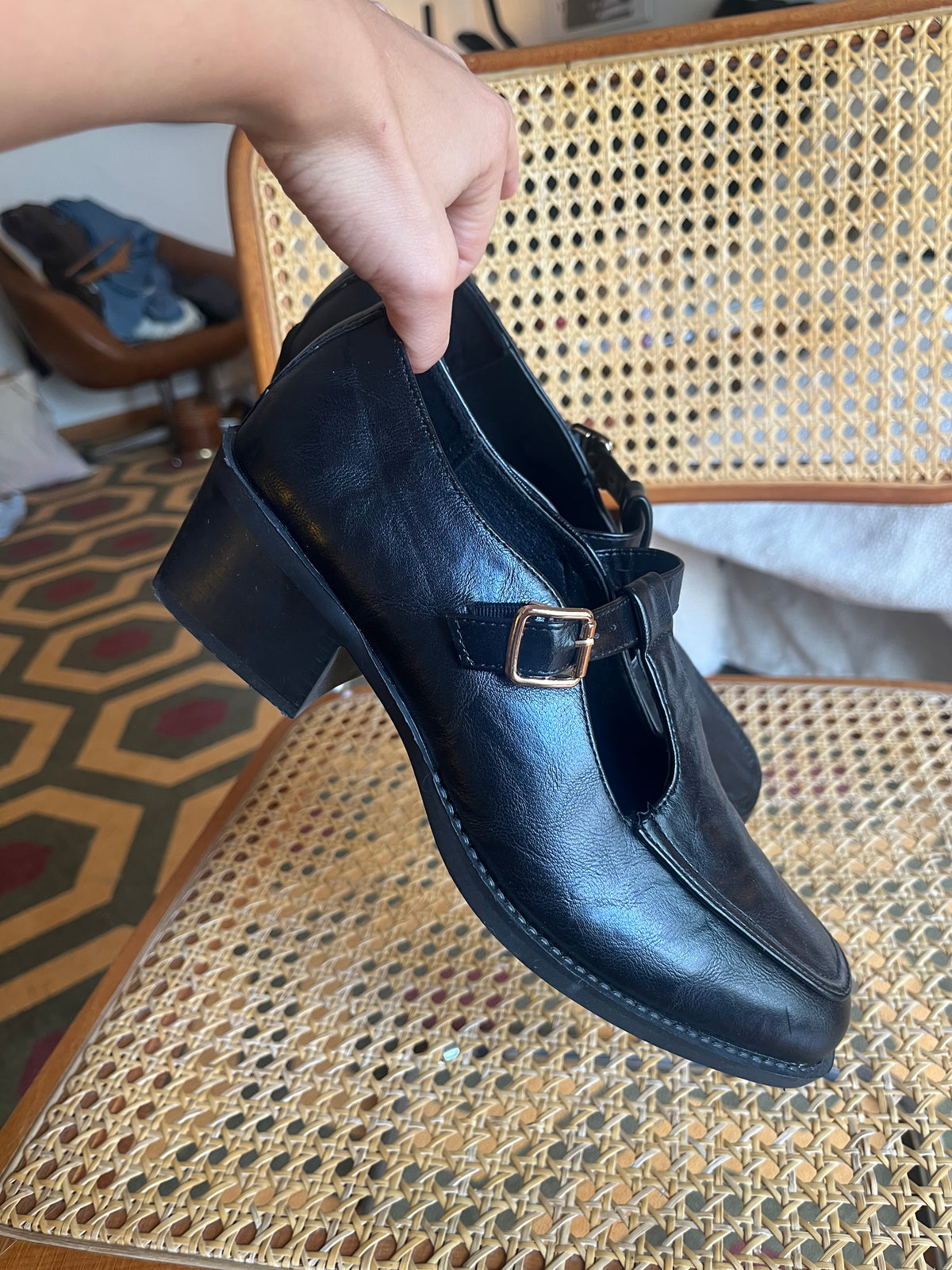 Classic black Mary Jane shoes with a T-strap, gold-tone buckle and a chic low block heel