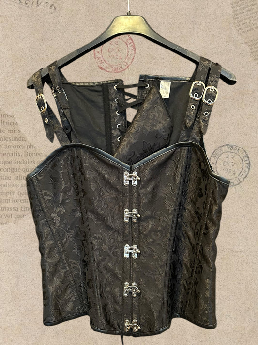Black brocade corset with elegant floral patterns. Silver clasps, buckle straps and adjustable lace-up back. A bold gothic Victorian statement piece.