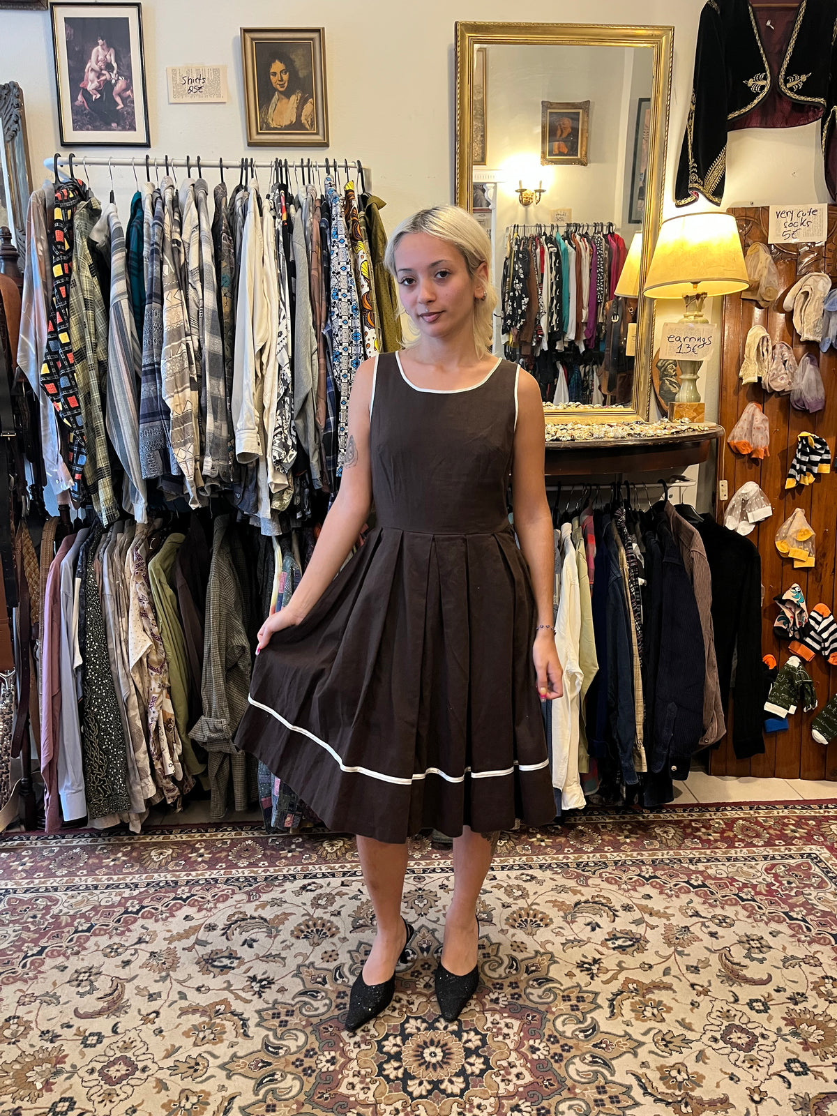 Elegant vintage-inspired wrap midi dress with a geometric print, contrasting black lapels and a tie waist. A timeless statement piece with a flattering silhouette and effortlessly chic feel.