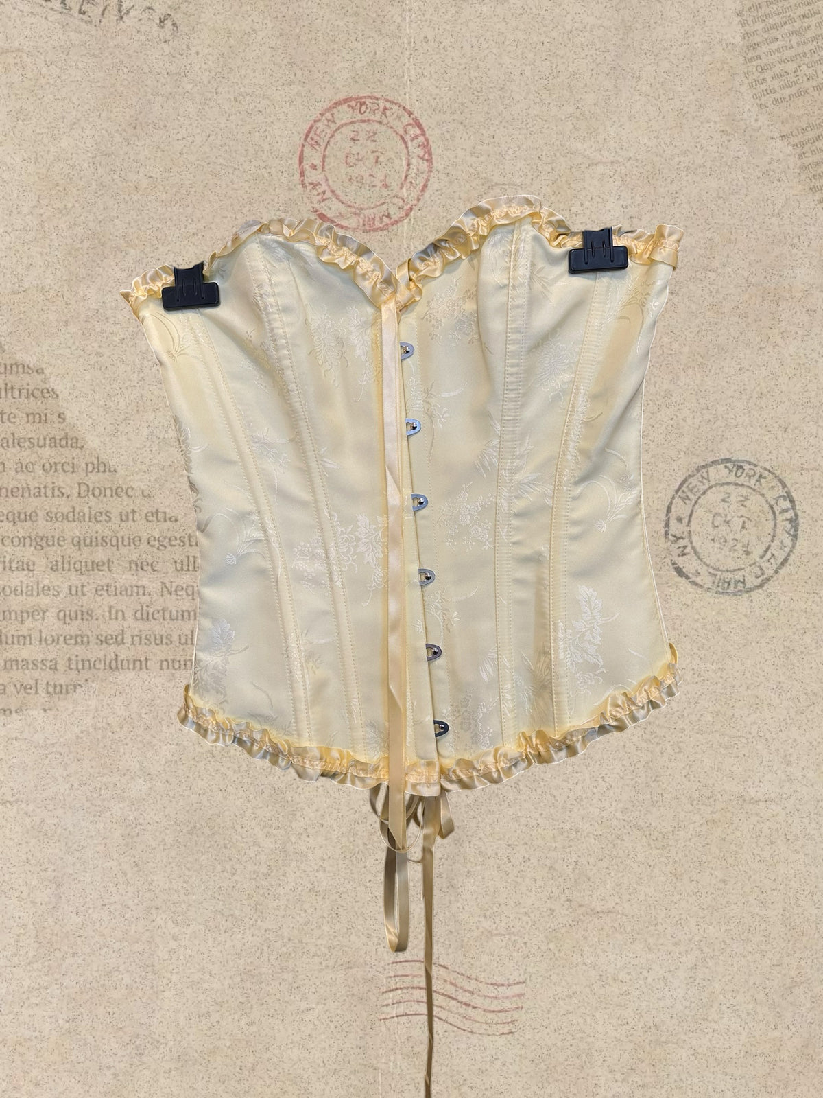 Victorian satin corset with delicate floral details and romantic ruffles. Features an adjustable lace-up back for a perfect fit. A timeless piece for dreamy, feminine looks.