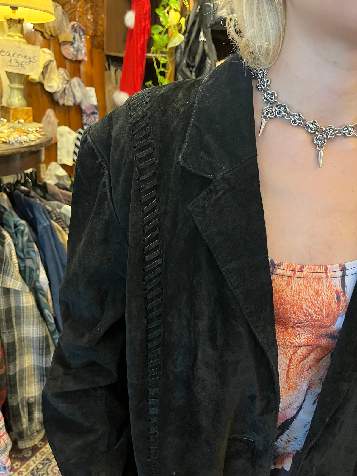 Vintage black suede blazer featuring intricate woven leather detailing along the front, shoulders, and back. Designed with a relaxed oversized fit, classic lapels, and understated button closure.