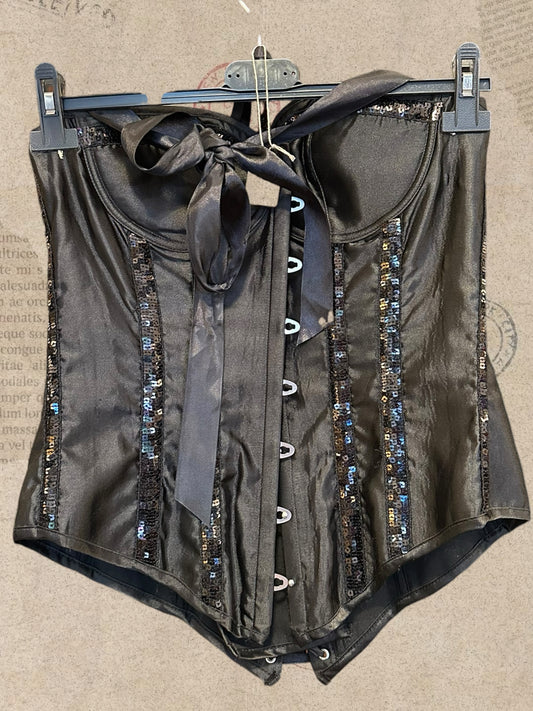 Black satin corset with sparkling sequin details. Features padded cups and adjustable lace-up back. A glamorous statement piece with gothic elegance.
