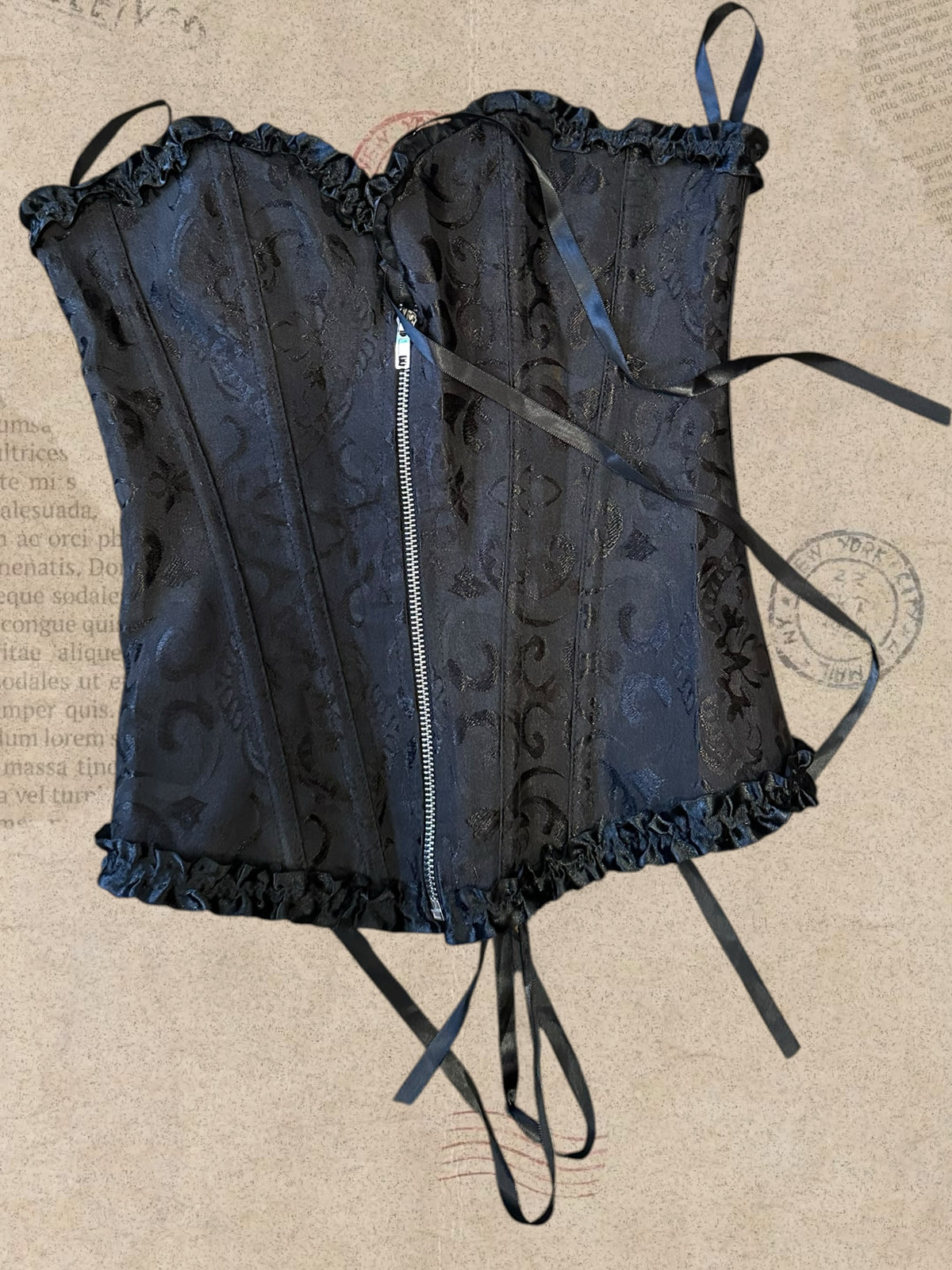 Black floral brocade corset with delicate ruffles. Front zipper and adjustable lace-up back. Elegant gothic Victorian style.