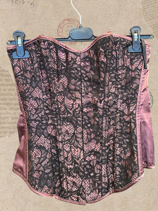 Dusty rose satin corset with intricate black floral lace. Adjustable lace-up back for a flattering fit. A romantic statement piece with gothic charm.