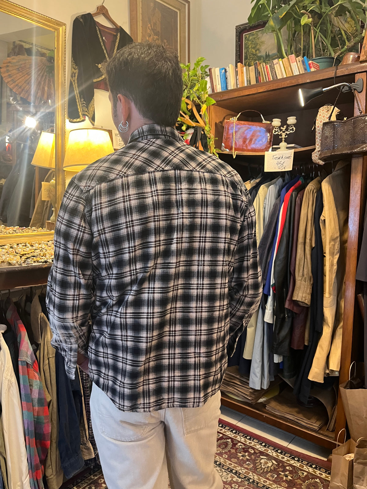 Vintage black and grey plaid flannel shirt featuring subtle red accents, snap buttons and double chest pockets. Relaxed fit with Western-inspired detailing for an effortless 90s grunge look