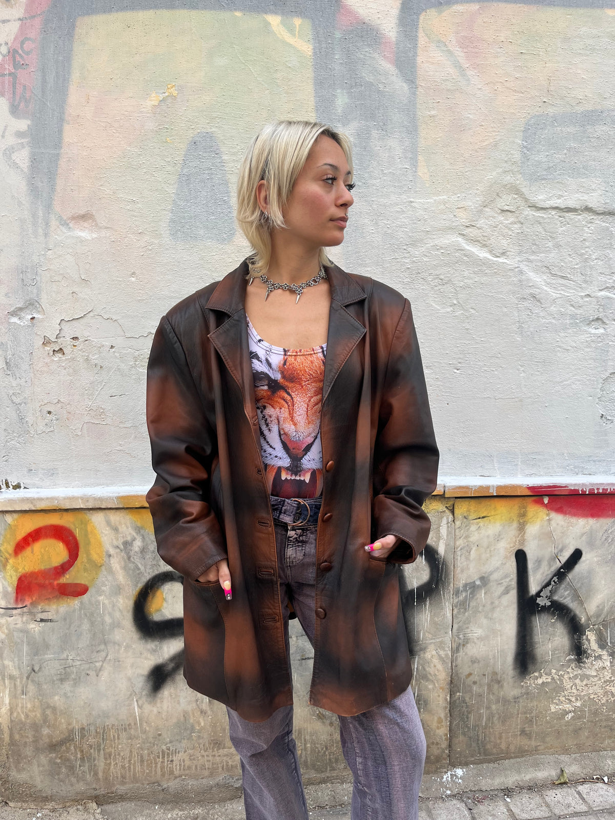 Oversized vintage leather blazer featuring a unique distressed brown and black finish. A statement piece with a relaxed fit, classic lapels, and button-front closure.