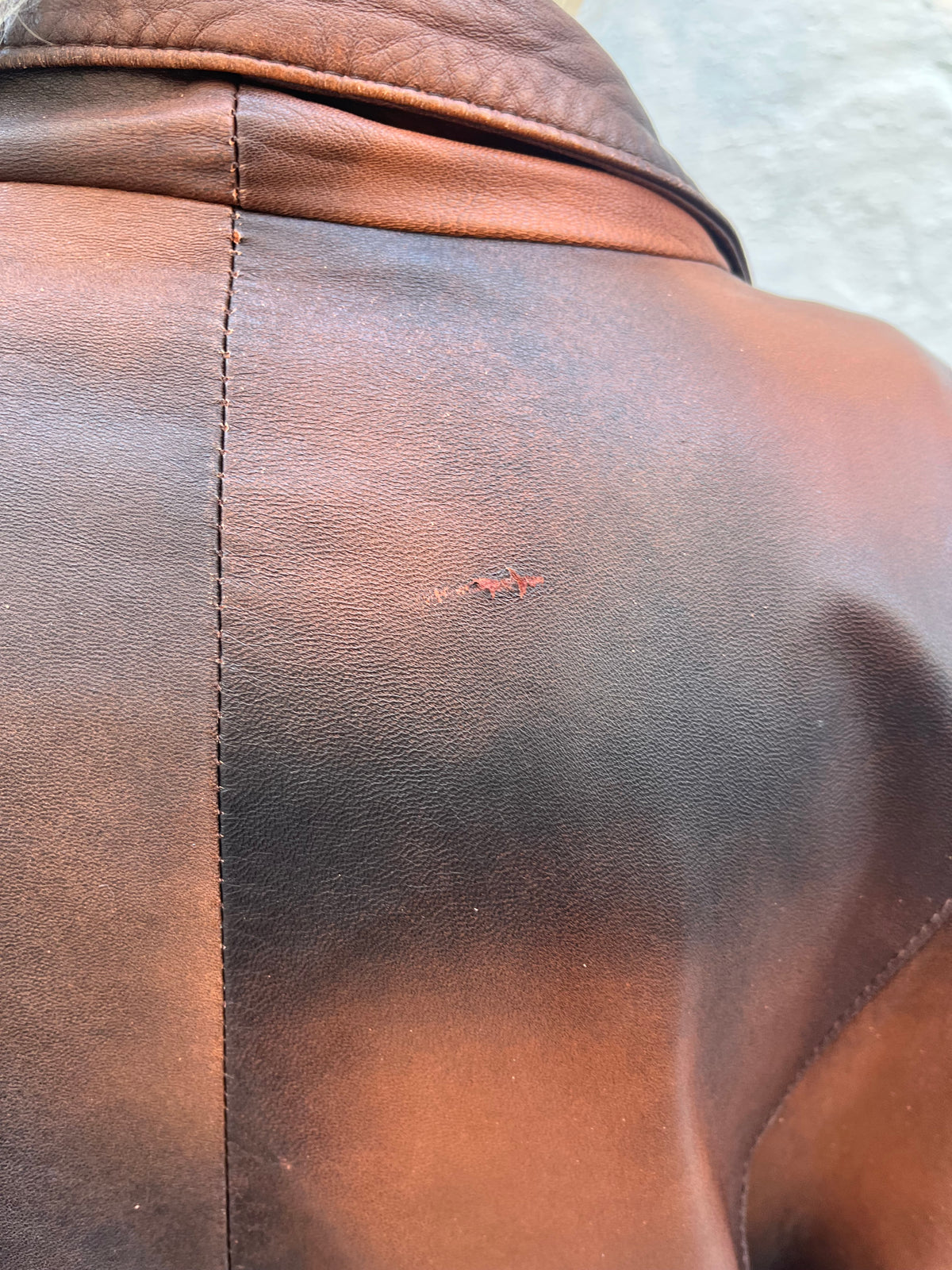 Oversized vintage leather blazer featuring a unique distressed brown and black finish. A statement piece with a relaxed fit, classic lapels, and button-front closure.