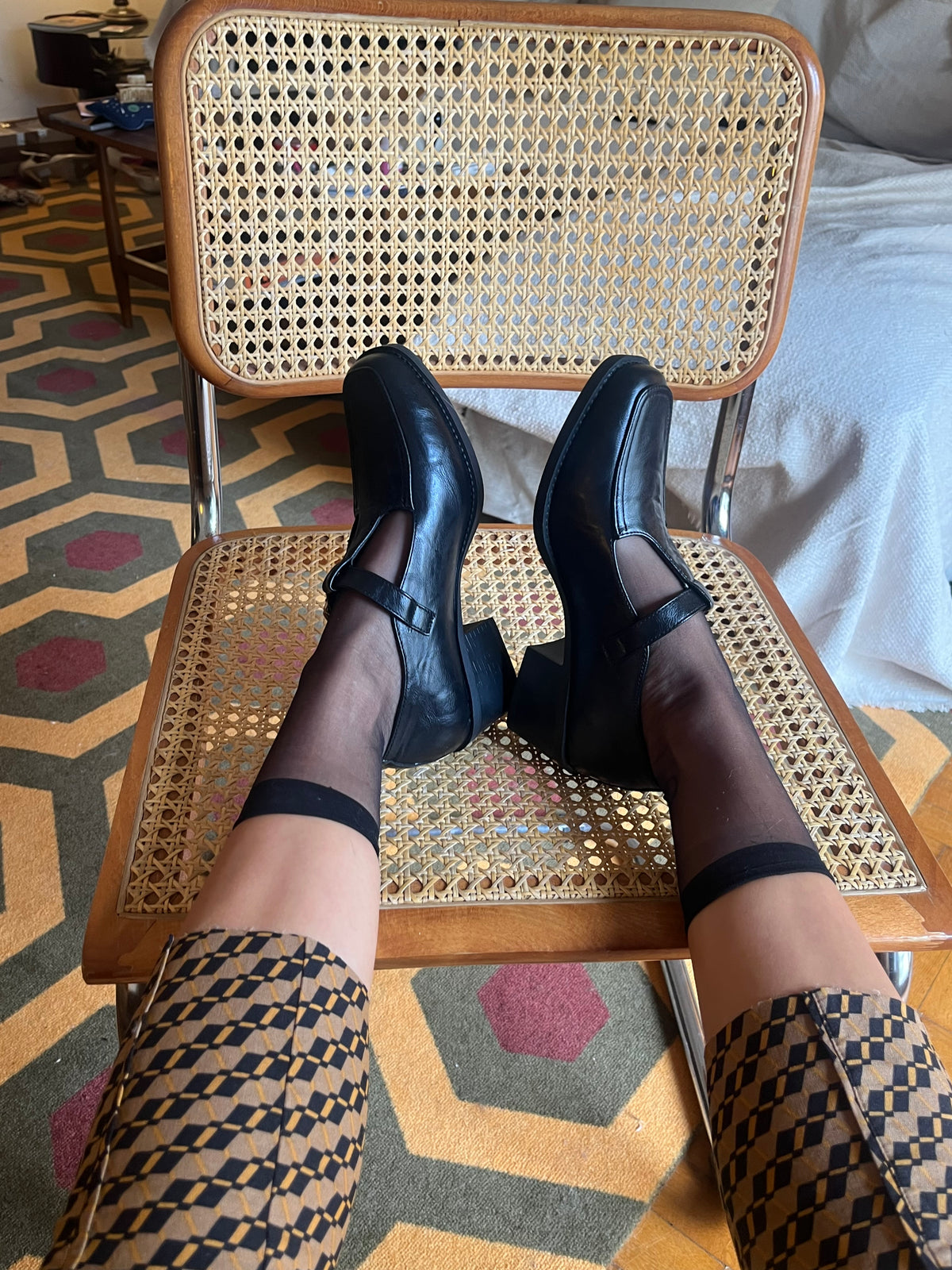 Classic black Mary Jane shoes with a T-strap, gold-tone buckle and a chic low block heel