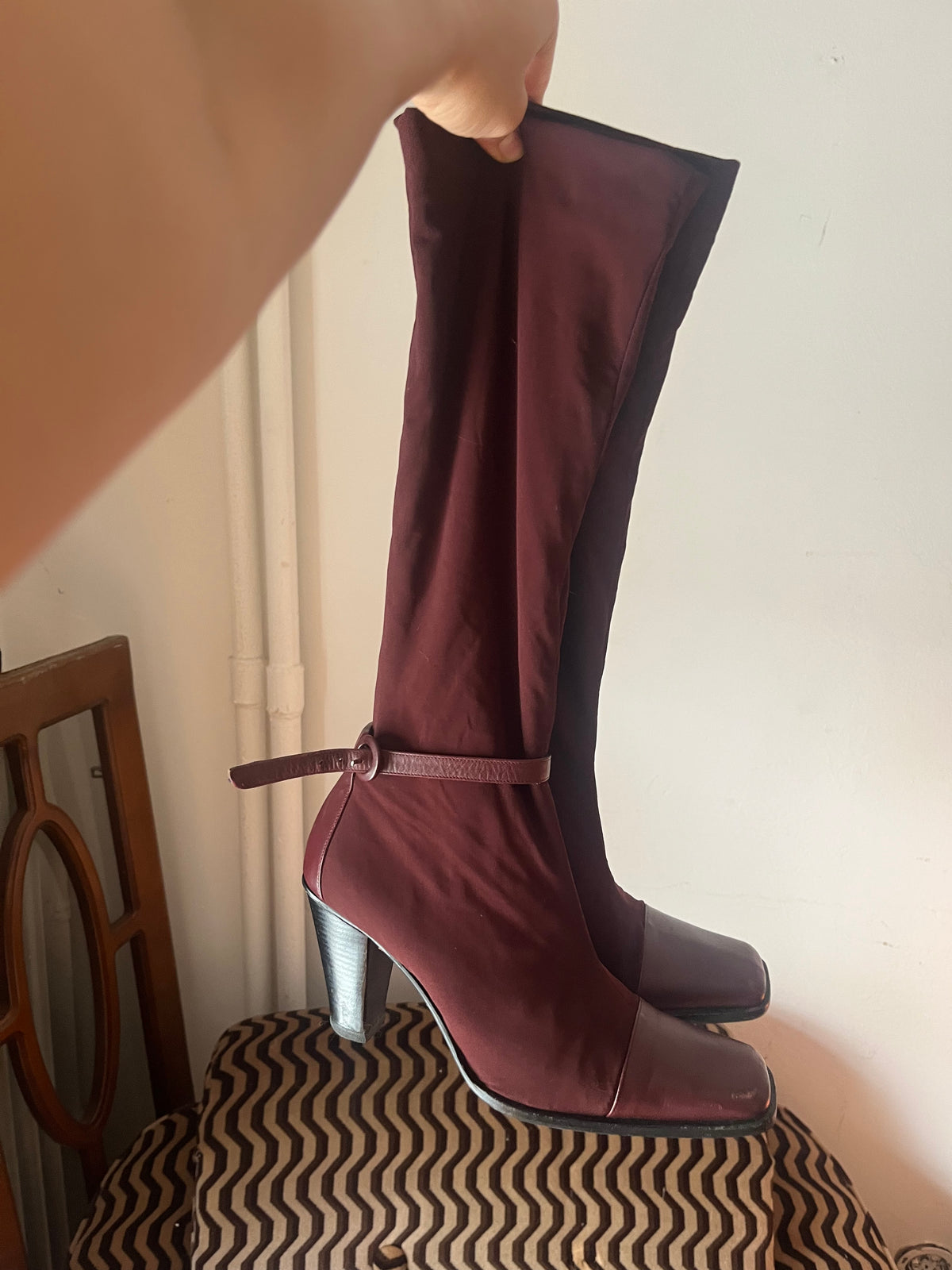 Deep burgundy sock boots with a sleek square toe and mid-height heel.