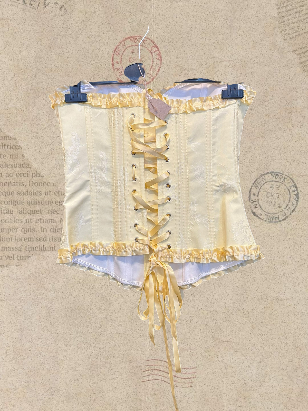 Victorian satin corset with delicate floral details and romantic ruffles. Features an adjustable lace-up back for a perfect fit. A timeless piece for dreamy, feminine looks.