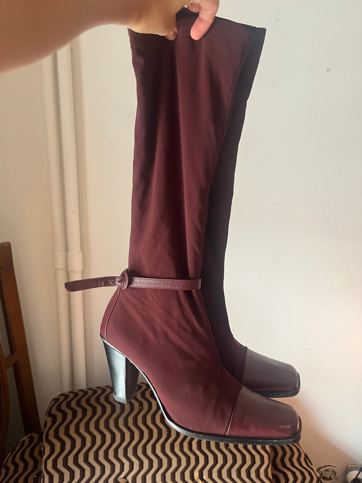 Deep burgundy sock boots with a sleek square toe and mid-height heel.