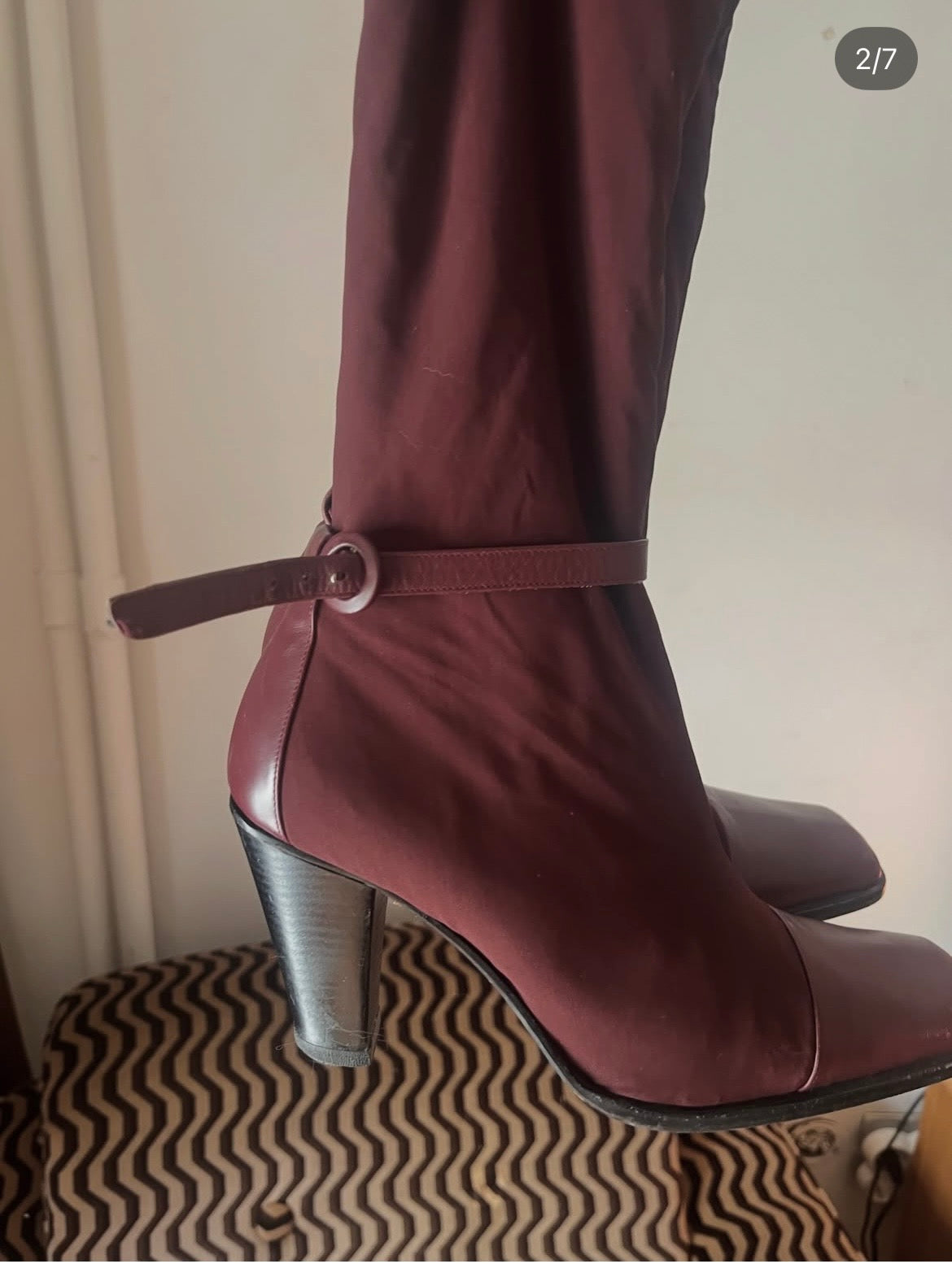Deep burgundy sock boots with a sleek square toe and mid-height heel.
