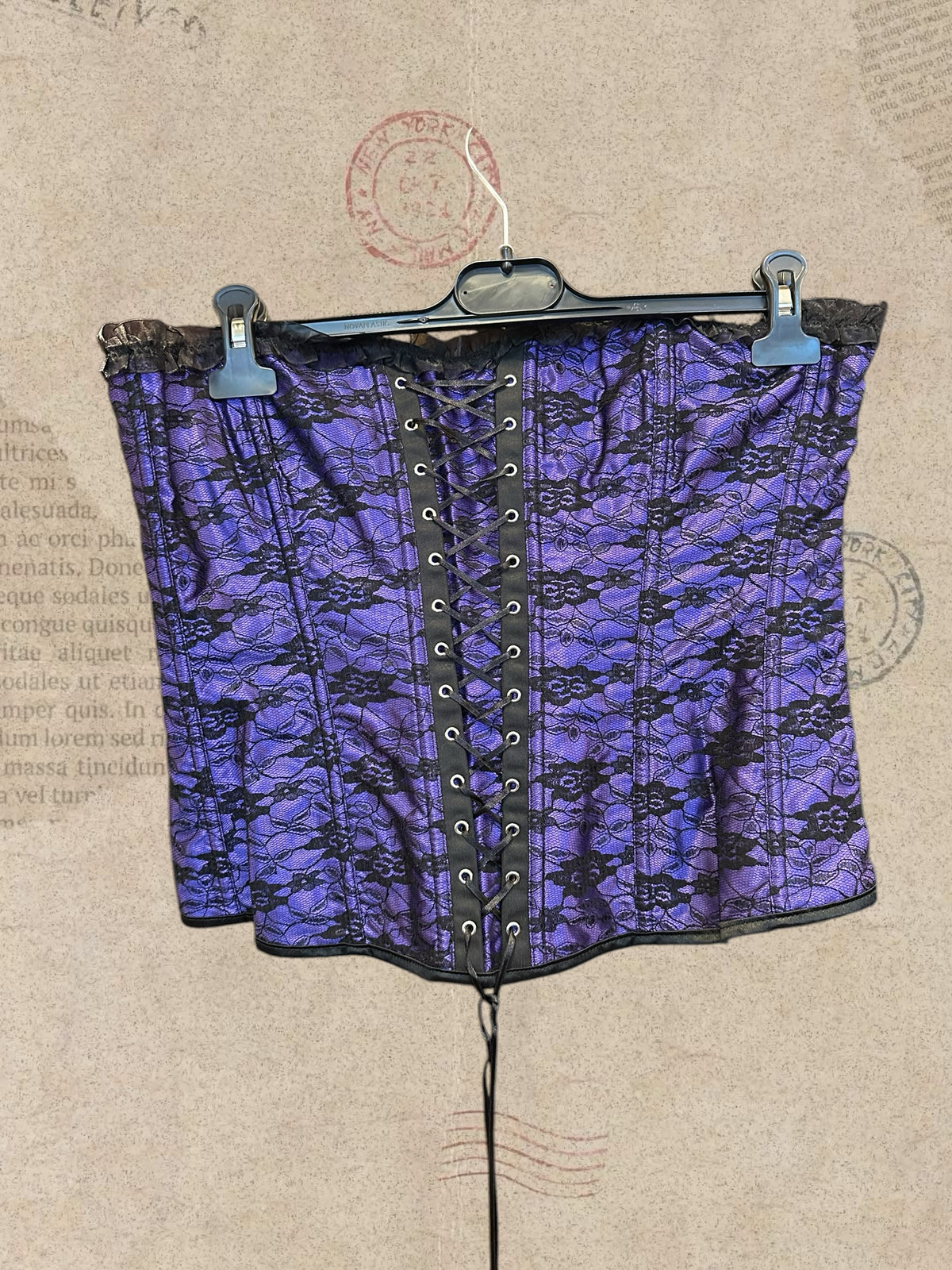 Gothic purple satin corset with black floral lace and ruffled trims. Adjustable lace-up design for a perfect fit. A romantic statement piece with Victorian charm.