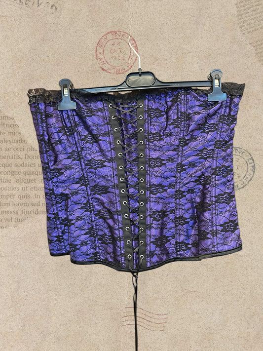 Gothic purple satin corset with black floral lace and ruffled trims. Adjustable lace-up design for a perfect fit. A romantic statement piece with Victorian charm.