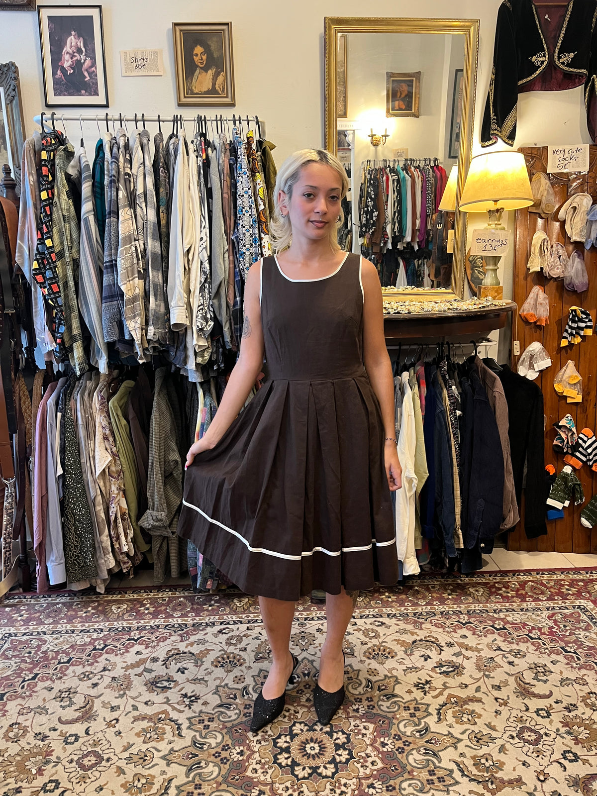 Elegant vintage-inspired wrap midi dress with a geometric print, contrasting black lapels and a tie waist. A timeless statement piece with a flattering silhouette and effortlessly chic feel.