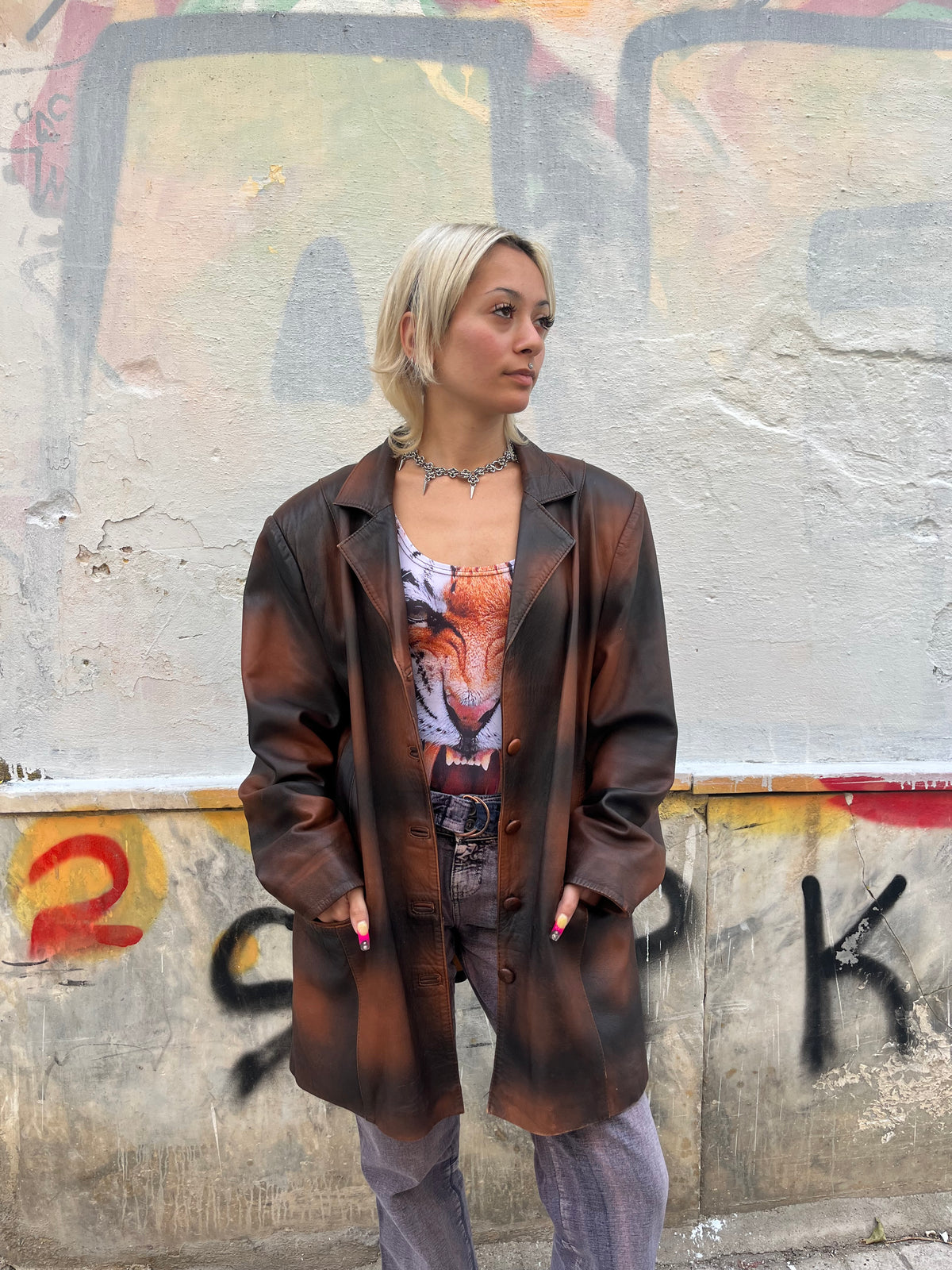Oversized vintage leather blazer featuring a unique distressed brown and black finish. A statement piece with a relaxed fit, classic lapels, and button-front closure.