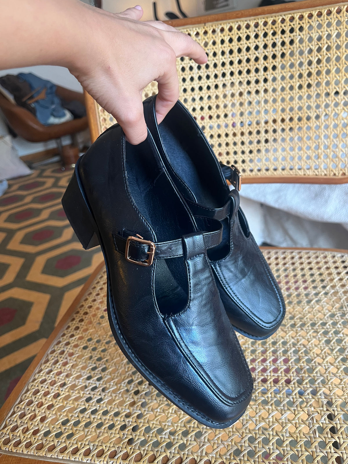 Classic black Mary Jane shoes with a T-strap, gold-tone buckle and a chic low block heel