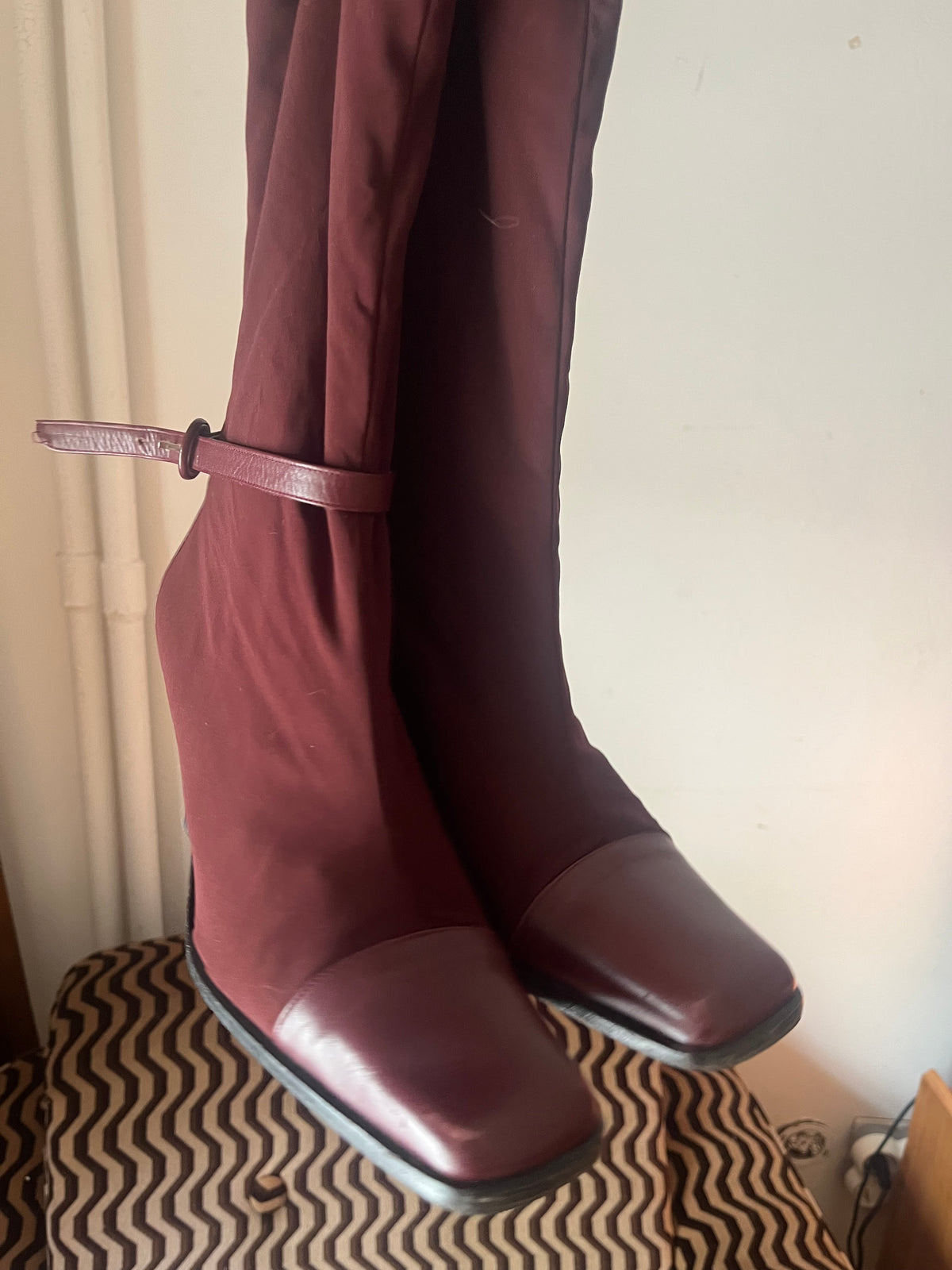 Deep burgundy sock boots with a sleek square toe and mid-height heel.