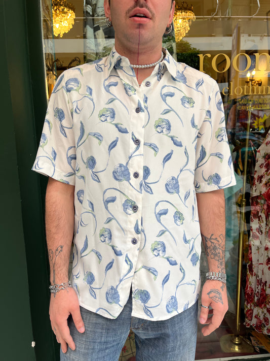 Floral button up shirt .Fits best M