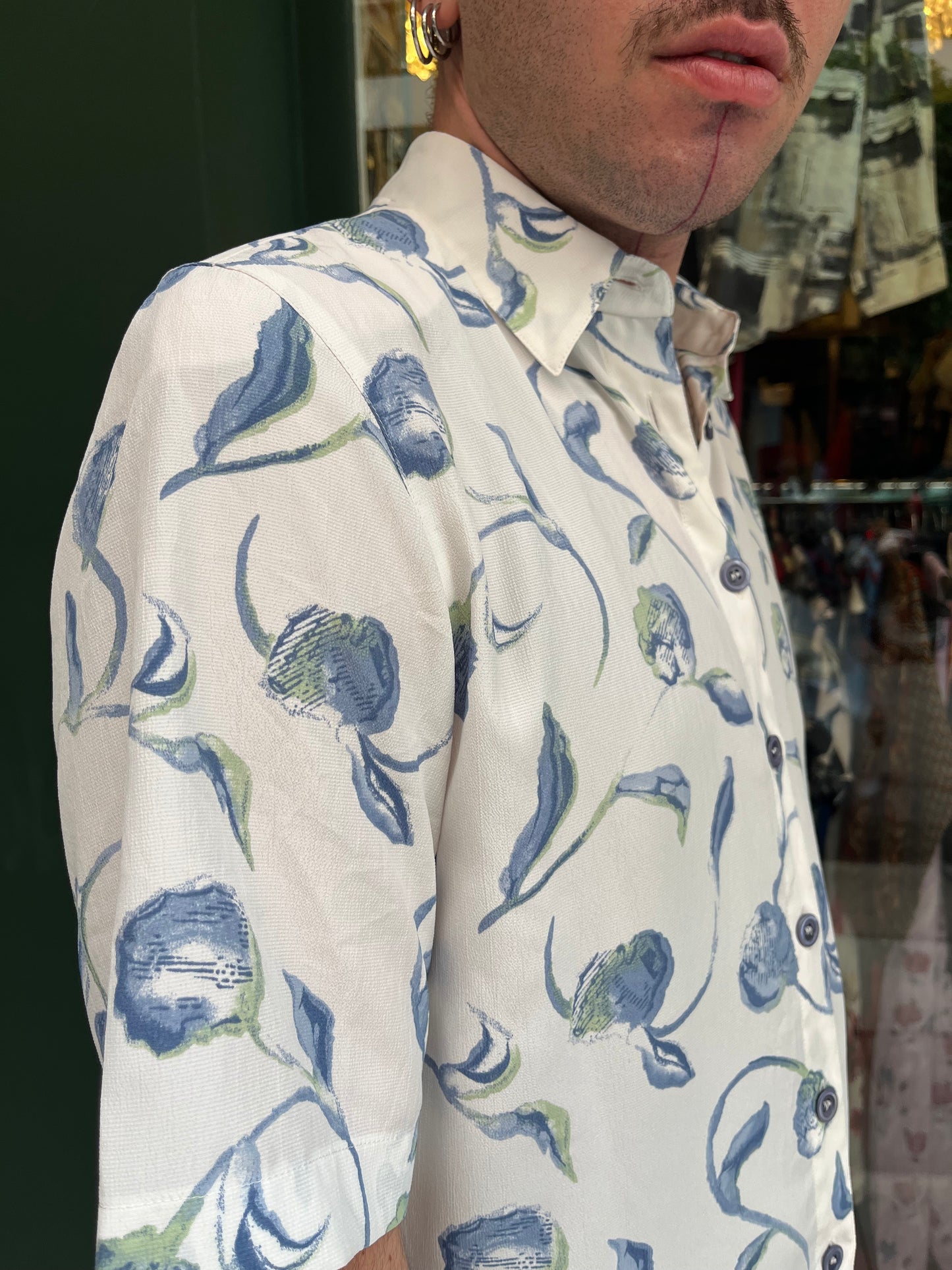 Floral button up shirt .Fits best M